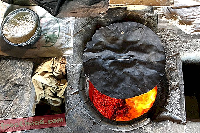 Sebelum membuat lavash, wanita kedai roti di Argel mula-mula membiarkan api terbakar untuk membolehkan lebih panas.